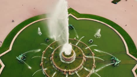 stunning-fountain-in-a-beautifully-manicured-park-showcasing-its-graceful-design-and-water-spraying-upwards-surrounding-grass-is-immaculately-groomed-water-shoots-up-from-various-points-slow-motion