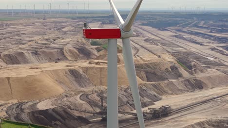 Close-up-of-win-turbine-in-front-of-Garzweiler-brown-coal-mine,-global-warming-concept