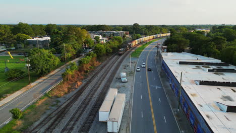 Aerial-view-of-heavy-a-long-freight-train-passing-through-suburb