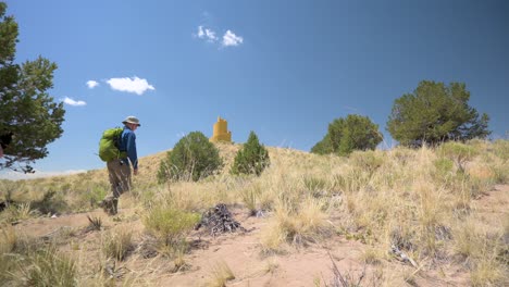 Couple-hiking-with-dog-to-the-Crestone-Ziggurat-during-the-day,-static