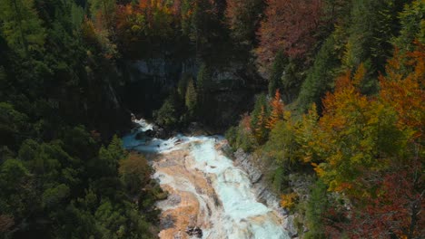 Drone-flight-bird's-eye-view-from-the-colorful-of-Karwendelbach-Waterfall-in-the-Karwendel-mountains-of-Austrias-Tyrol,-very-close-to-Scharnitz,-recorded-in-autumn