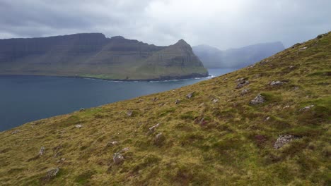 Villingardalsfjall-mountain-slope-with-view-of-Bordoy-and-foggy-Kunoy-Island-in-Faroe-Islands