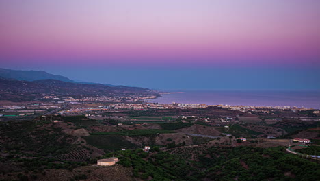 Aerial-view-of-sunset-with-the-lights-turning-on-in-the-city-of-Torre-del-Mar-in-Spain