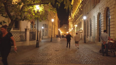 Old-town-streets-with-tourists-at-night,-Bucharest,-Romania