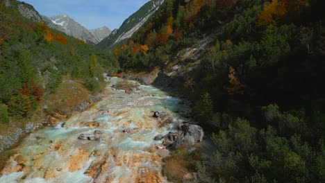 Drone-flight-over-the-colorful-of-Karwendelbach-river-in-the-Karwendel-mountains-of-Austrias-Tyrol,-very-close-to-Scharnitz,-recorded-in-autumn