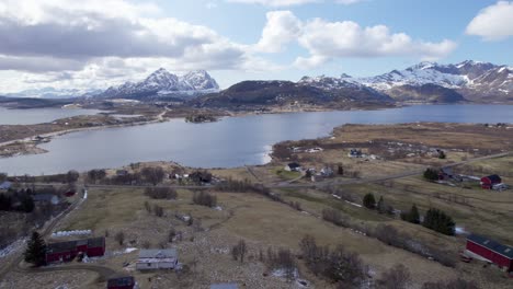 Aerial-dolly-shot-of-the-historical-Viking-village-borg-in-Lofoten,-Northern-Norway,-partly-cloudy-and-sunny
