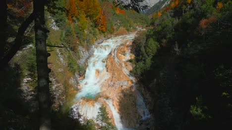 Drone-shot,-flying-over-the-colorful-waterfall-of-Karwendel-Mountains-in-Austrias-Tyrol,-very-close-to-Scharnitz,-recorded-in-october