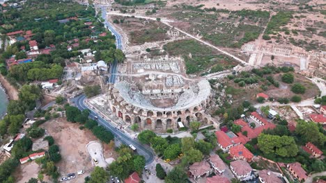 Aerial-flyover-view-above-the-Side-amphitheatre,-Turkey-in-traditional-residential-aged-old-town