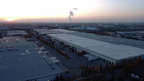 Flying-over-warehouses-towards-Shepard-Energy-Centre-in-Calgary-during-sunrise