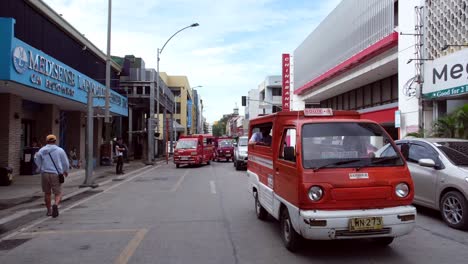 Multiple-types-of-vehicles-run-on-the-road-with-commercial-buildings-on-both-sides-in-the-city-center-of-Davao,-the-Philippines