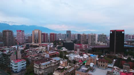 Aerial-orbit-establishing-over-Lastarria-neighborhood-and-Gabriela-Mistral-Cultural-Center-with-the-Bruna-Palace-at-the-edge-of-the-street,-old-residential-buildings,-Santiago,-Chile