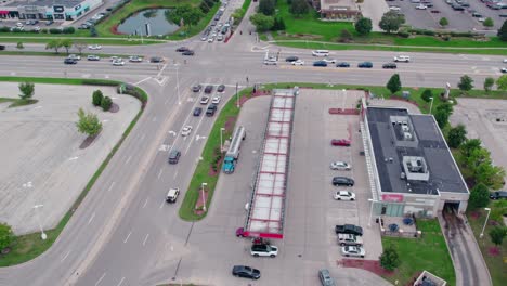 Aerial-view-over-semi-truck-tanker-bringing-fuel-for-gas-station,-location-in-Vernon-Hills,-Illinois,-USA