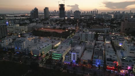 Static-aerial-establishing-overview-of-Miami-South-Beach-district-at-dusk,-flashing-building-lights