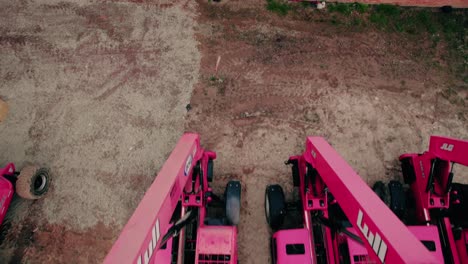 Lull-jlj-forklifts-red-tractors-aligned-in-a-construction-parking-lot