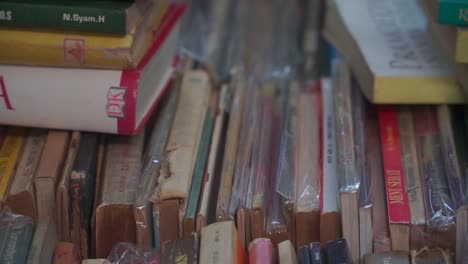 Panning-shot-over-old-Indonesian-books-displayed-in-a-pile