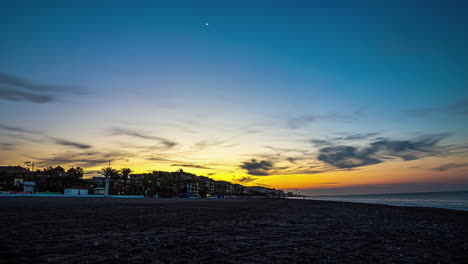 Sonnenaufgang-Vom-Strand-Von-Torrox-In-Spanien-Mit-Der-Stadt-Und-Palmen-Im-Hintergrund