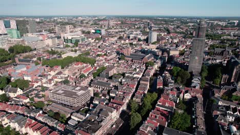 Aerial-drone-shot-flying-high-over-residential-houses-and-roads-along-the-Historic-City-Center-of-Utrecht-in-the-Netherlands-on-a-sunny-day