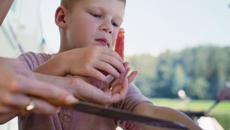 Handheld-video-of-boy-eating-watermelon-at-a-picnic
