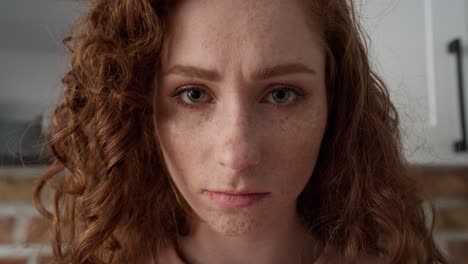 Close-up-of-young-caucasian-woman-with-red-curly-hair