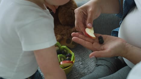 Handheld-video-of-mother-convincing--baby--to-eat-some-fruit.