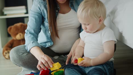 Handheld-video-of-pregnant-mother-playing-with-her-toddler-son.