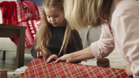 Handheld-video-of-grandmother-and-granddaughter-packing-presents-together