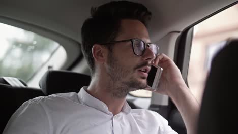 Businessman-using-a-phone-in-a-car