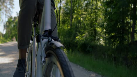 Tilt-down-vide-of-man-riding-a-bike-on-a-sunny-day