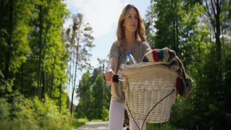 Front-view-of-woman-riding-a-bike-on-a-sunny-day.