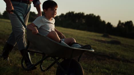 Video-of-smiling-boy-riding-on-wheelbarrows