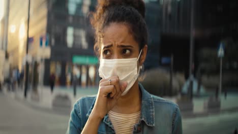 Front-view-video-of-woman-coughing-in-a-protective-mask