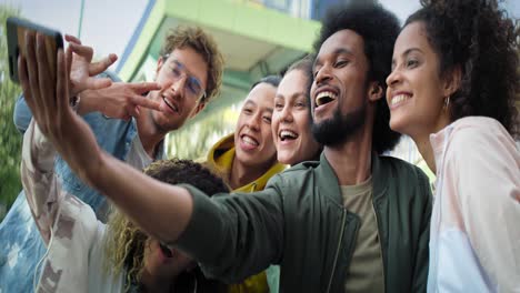 Video-of-group-of-young-people-doing-selfie-outdoors