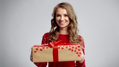 Smiling-woman-holding-a-big-gift