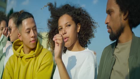 Video-of-young-people-talking-to-each-other-outdoors