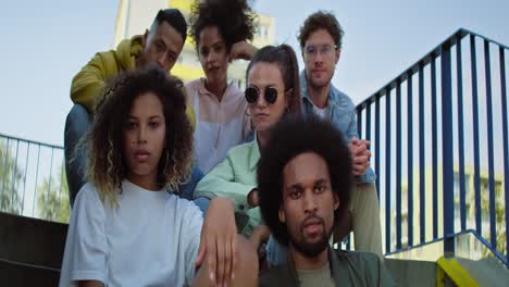 Video-portrait-of-young-group-of-friends-sitting-on-the-stairs