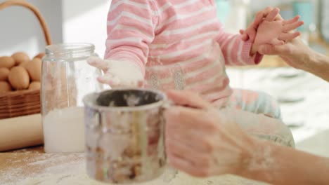 Handheld-view-of-mum-and-daughter-playing-with-flour