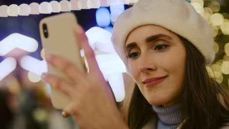 Close-up-video-of-woman-browsing-phone--and-drinking-mulled-wine