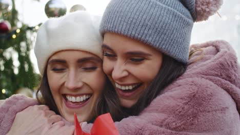 Video--of-two-female-friends-on-Christmas-time-outdoors