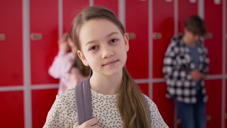 Video-portrait-of-smiling-girl-standing-at-school