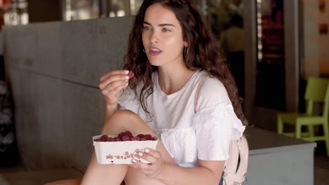 Young-woman-eating-raspberries