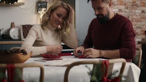 Adult-couple-making-Christmas-decoration-at-the-table