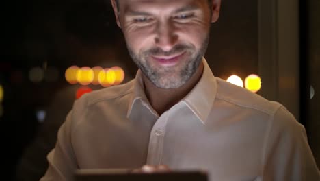 Mature-men-using-a-tablet-at-night