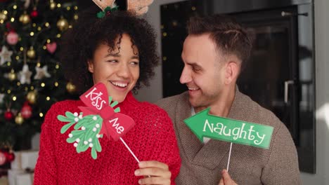 Handheld-view-of-playful-couple-celebrating-Christmas-together