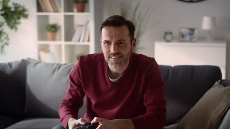 Man-playing-video-game-at-home