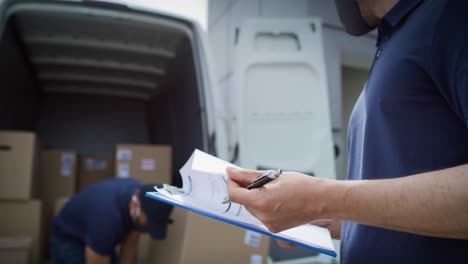 Video-of-couriers-unloading-packages-and-checking-documents