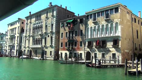 Venice-water-taxi-cruising-past-down-The-Grand-Canal-in-Venice,-Italy