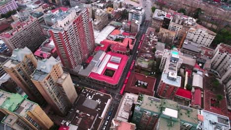 Aerial-view-establishing-on-symmetrical-streets-of-downtown-Santiago-Chile,-San-Pedro-church,-ancient-and-representative-architecture