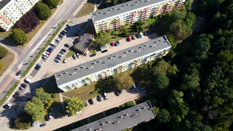Aerial-top-down-flight-over-block-neighborhood-in-Polish-city-with-parking-cars-and-rooftop-of-house