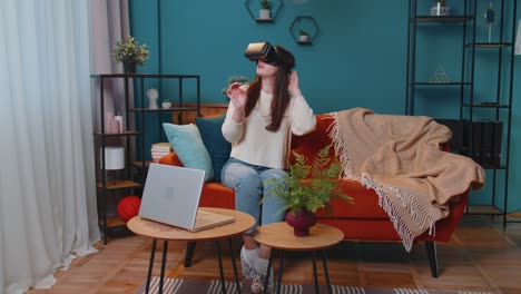 Young-woman-use-virtual-reality-headset-glasses-at-home,-enjoying-video-concept-moving-hands-in-air