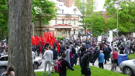 Large-Group-Of-Protesters-Marching-Through-Québec-City-During-The-G7-Summit-Carrying-Flags-And-Banners